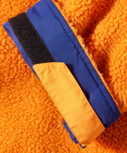 Load image into Gallery viewer, Close-up of thick orange sherpa fleece lining inside Selkie recycled robe.